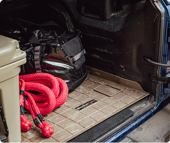 WeatherTech Cargo Liner installed in trunk with bags and rope in trunk